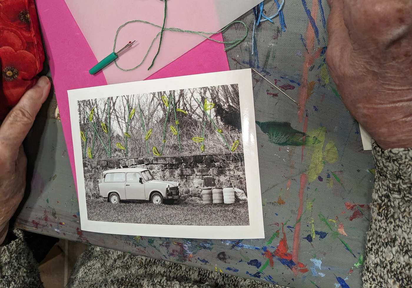 Hands embroidering on photo during workshop