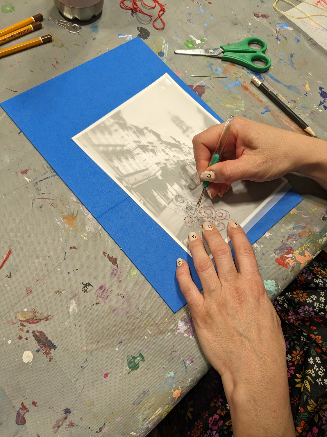 Hands embroidering on photo during workshop