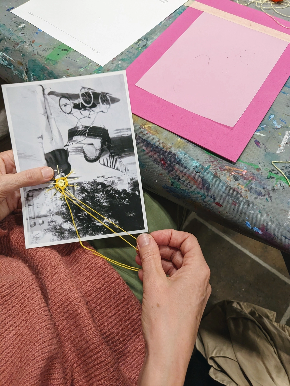 Hands embroidering on photo during workshop