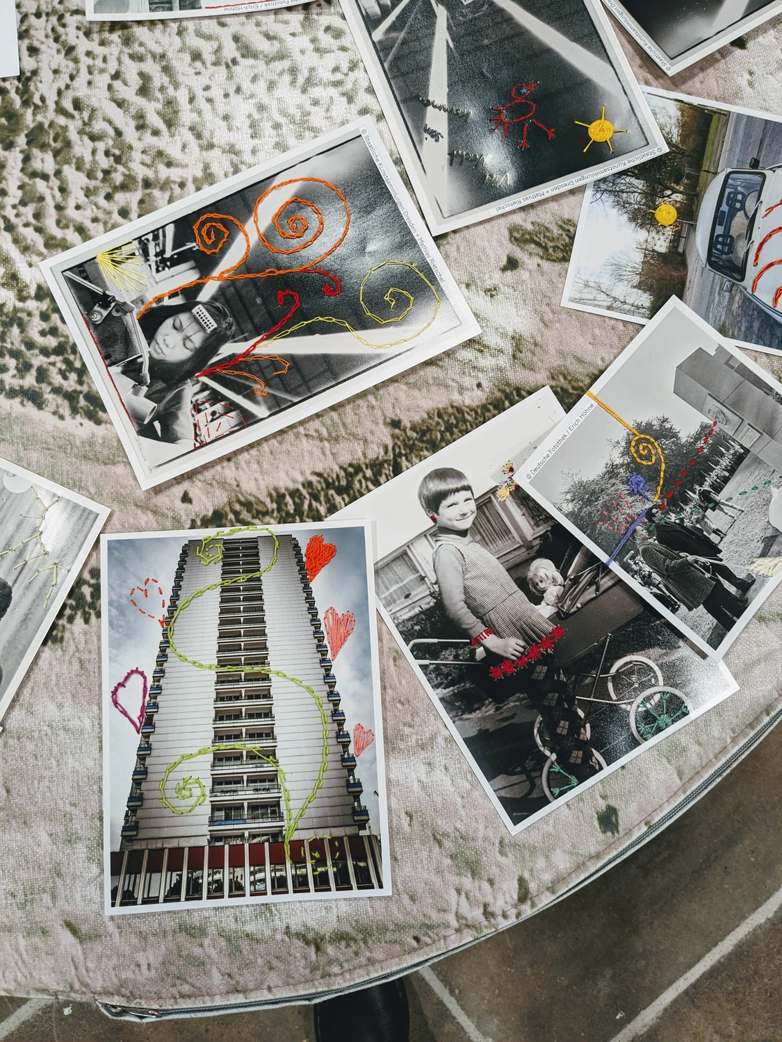 Embroidered photographs created by workshop participants
