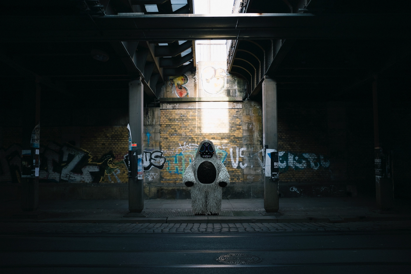 A train underpass in Dresden, no one else present. He stood at the far end, as if waiting for something.
