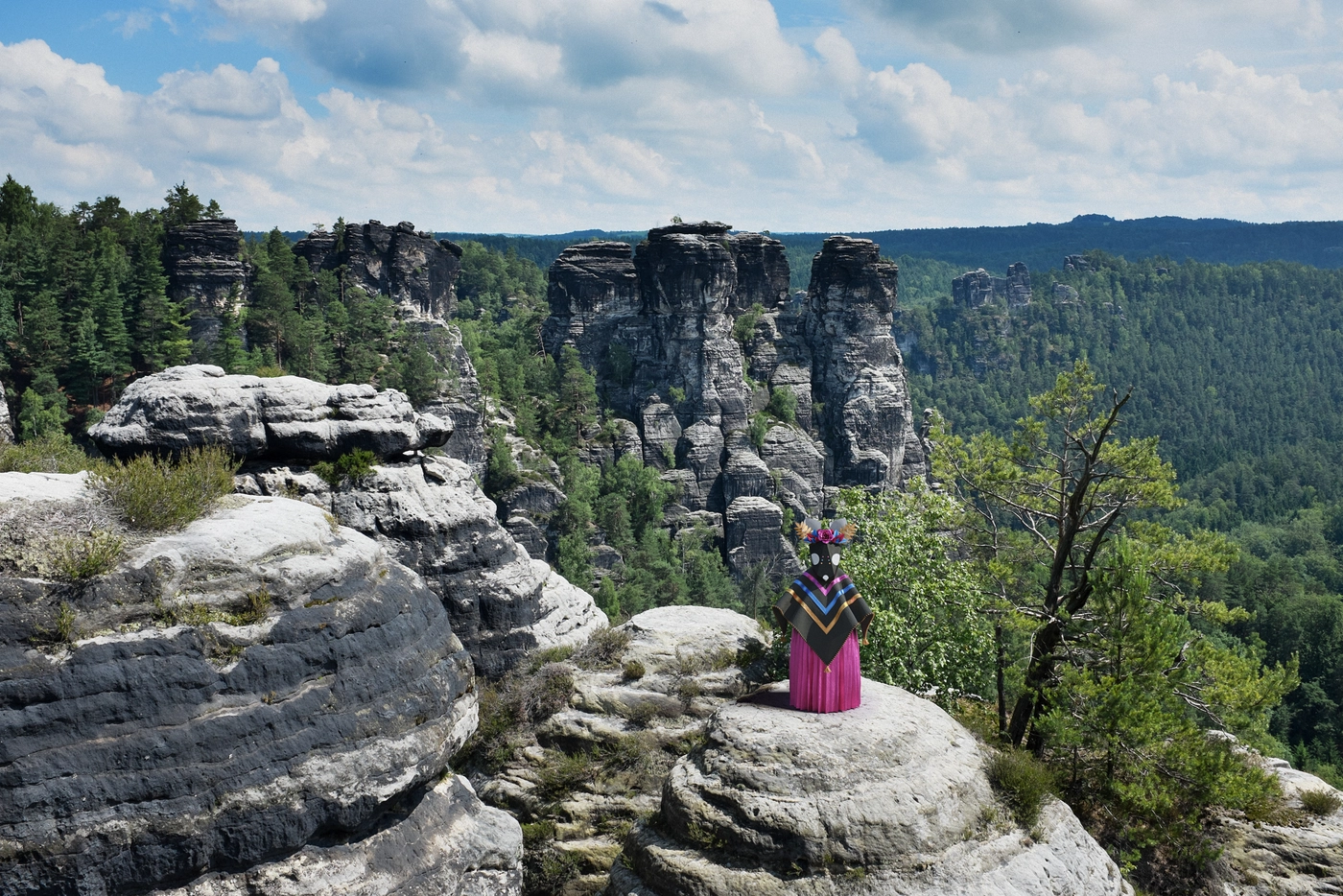 A lookout over sandstone peaks, the valley laid out below. She faced the view the way someone studies a map before a long walk.