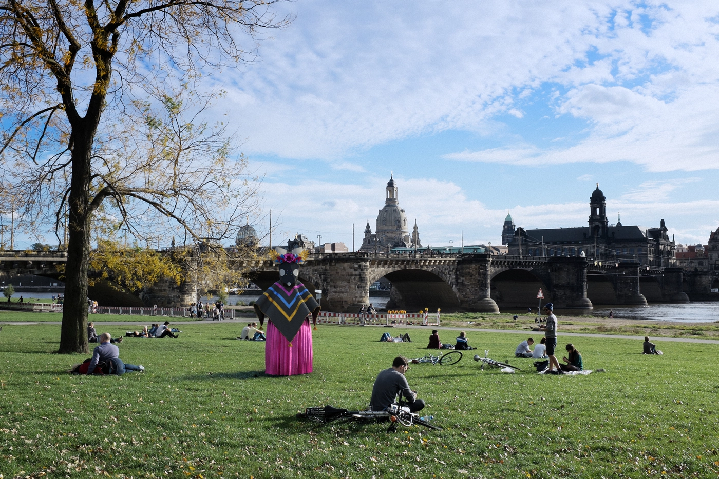The Elbe meadow, the Frauenkirche standing watch across the water. People filled the grass that Sunday; none of them turned to look as she passed through.